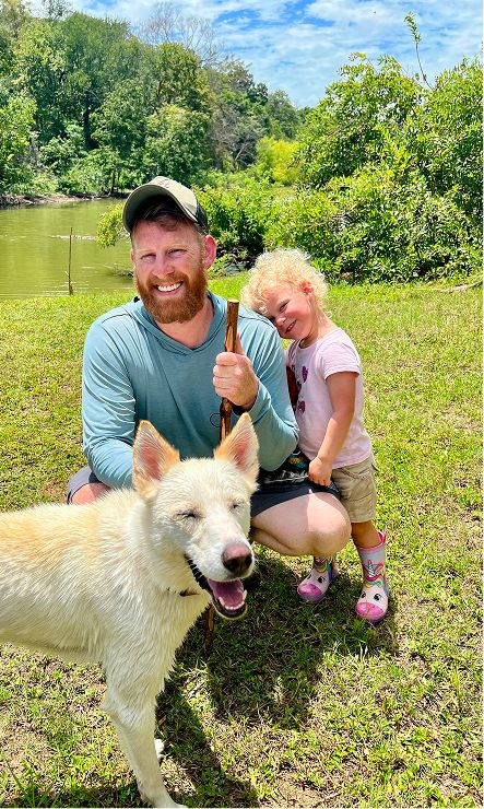 A happy man, child and dog